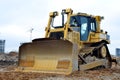 Bulldozer during of large construction jobs at building site.  Crawler tractor dozer for earth-moving. Land clearing, grading, Royalty Free Stock Photo