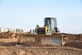 Bulldozer during of large construction jobs at building site. Crawler tractor dozer for earth-moving. Royalty Free Stock Photo