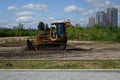 Bulldozer leveling gravel for new road construction