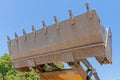 Bulldozer lifting bucket. Excavator bucket against sky Royalty Free Stock Photo