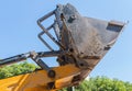 Bulldozer lifting bucket. Excavator bucket against sky Royalty Free Stock Photo