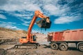 bulldozer loading dumper truck during highway construction site