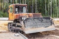 Bulldozer machine is leveling construction site. Earthmover with caterpillar is moving earth. Close-up. Construction heavy Royalty Free Stock Photo