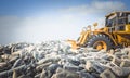 Bulldozer mouve mountains of plastic bottles Royalty Free Stock Photo