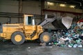 Bulldozer move pile of waste in a landfill