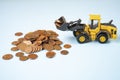 A bulldozer moving Euro cents coins Royalty Free Stock Photo