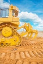 Bulldozer ob sand rear vie with background sky Royalty Free Stock Photo