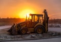 Bulldozer parked with no driver at sunset