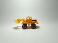 Bulldozer plastic toy on white background Royalty Free Stock Photo
