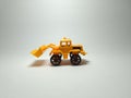 Bulldozer plastic toy on white background Royalty Free Stock Photo