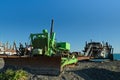 Bulldozer pulling a boat up the beach, Ngawi, New Zealand