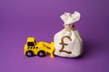 A bulldozer pushes a british pound sterling money bag. Ineffective use of funds.