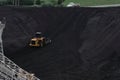 Bulldozer Pushing Coal Up Hill