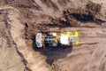 Bulldozer pushing large amount of fresh soil, Aerial shot.