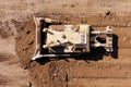 Bulldozer pushing large amount of fresh soil, Aerial shot.