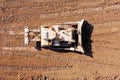 Bulldozer pushing large amount of fresh soil, Aerial shot.