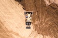 Bulldozer pushing large amount of fresh soil, Aerial shot.