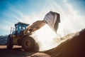 Bulldozer putting biomass on pile for composting