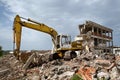 Bulldozer removes the debris from demolition of derelict buildings Royalty Free Stock Photo