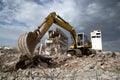 Bulldozer removes the debris from demolition of derelict buildings Royalty Free Stock Photo