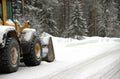 Bulldozer removing snow on a road Royalty Free Stock Photo