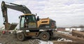 Bulldozer Rides on Sandy Road. Construction Machinery At Work On Building A House. Different Types Of Tractors And