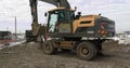 Bulldozer Rides on Sandy Road. Construction Machinery At Work On Building A House. Different Types Of Tractors And