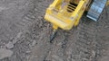 Bulldozer with ripper shank penetrate and loosen the soil on construction site