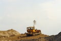 Bulldozer on sand heap