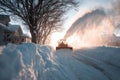 A bulldozer is shoveling snow in the city. Generative AI. Royalty Free Stock Photo