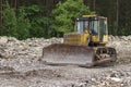 Bulldozer standing in forest for deforestation. Royalty Free Stock Photo