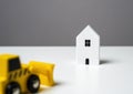 Bulldozer is about to demolish a house. Royalty Free Stock Photo