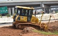 A bulldozer at work on a highway ramp