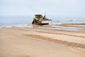 Bulldozer working at seashore Royalty Free Stock Photo