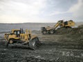 bulldozers and excavators carry out coal mining activities at the site