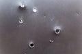 bullet hole in armored metal plate