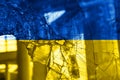 Bullet hole, cracks in the glass on a yellow-blue background. Ukraine flag on broken glass texture. Concept, Russian-Ukrainian war