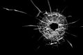 Bullet hole in the glass. Isolated on a black background. Royalty Free Stock Photo