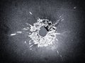 Bullet hole in the metal plate, black and white photo Royalty Free Stock Photo