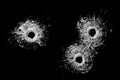 Bullet holes in glass isolated on black