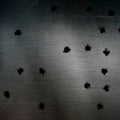 Bullet holes in scratched metal surface Royalty Free Stock Photo