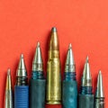 Bullet and pens on red background. Freedom of the press is at risk concept. World press freedom day concept Royalty Free Stock Photo