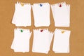 Cork bulletin or notice board with pinned untidy torn notepaper, copy space Royalty Free Stock Photo