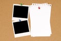 Two polaroid photo frames pinned to a cork board background with blank torn notepaper, copy space Royalty Free Stock Photo