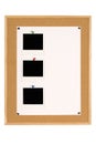 Vertical row of three Polaroid photo frames on notice board with white poster paper copy space Royalty Free Stock Photo