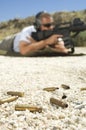 Bullets On Ground With Man Aiming Machine Gun Royalty Free Stock Photo