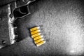 Bullets and handcuffs. Close-up of 9mm pistol. Gun and weapon with bullets amunition on black backround. Top view. Royalty Free Stock Photo