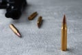 Bullets and handgun on light grey table, closeup. Space for text