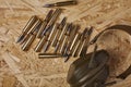 Bullets on wooden texture with hearing protection Royalty Free Stock Photo