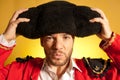 Bullfighter putting on big montera hat humor Royalty Free Stock Photo